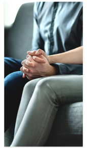 Couple holding hands sitting on couch - closeup on hands - South Jersey Fertility