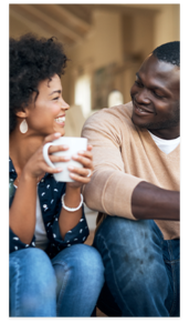 Young black couple smiling over coffee