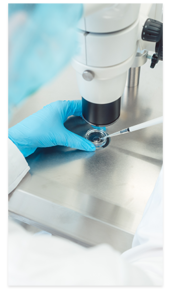 clinician using microscope and lab equipment for fertility treatment